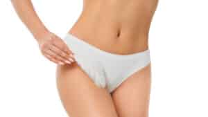 Woman touching with feather her genitals wearing panties
