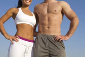 Couple, both wearing workout clothes, show off their toned bodies after losing weight and Physiq body contouring