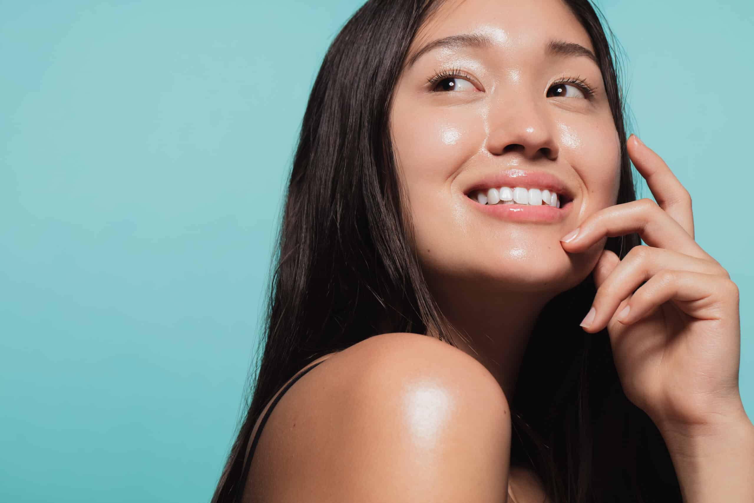Beautiful young woman with glowing skin smiles after a Skinwave facial